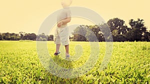 Energy, summer and baby boy playing on field in excitement for adventure, discovery or to explore nature. Kids, growth