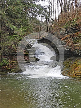 Enfield gorge trail waterfall at Robert H. Treman State Park in winter