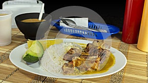 Enfocado de costilla -Ribbed Shrink in Spanish language- plate of bone rib meat accompanied with white rice, cassava and avocado photo
