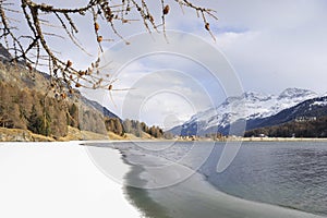 Engadin valley in Switzerland Sils Maria village with snow on Alp mountains and frozen lake