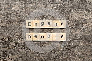 ENGAGE PEOPLE word written on wood block. ENGAGE PEOPLE text on cement table for your desing, concept