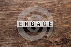 Engage - word concept on building blocks, text