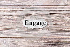 ENGAGE of the word on paper. concept. Words of ENGAGE on a wooden background