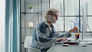 Engaged blond musician plays electric piano at gray desk