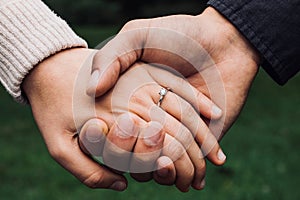 An engaged couple with engagement ring photo