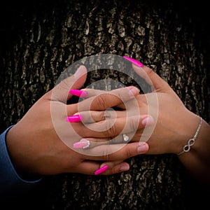 Engaged couple in photo session, focus on their hands