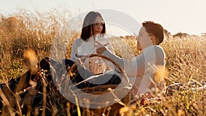 Engaged Couple Picnics In The Field at sunset