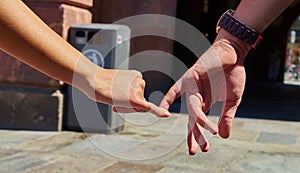 Engaged couple walking in city and holding hands