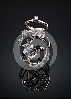 Engagement diamond wedding ring group isolated on black background