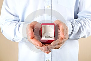 Engagement / marriage / wedding proposal scene. Close up of man handing the expensive gold platinum diamond ring to his bride.