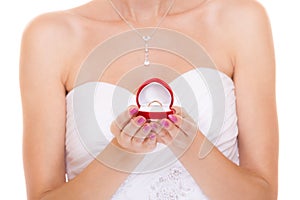 Engagement ring box in woman bride hands.