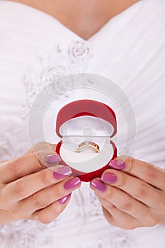 Engagement ring box in woman bride hands.