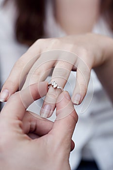 Engagement ring into a finger