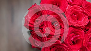 engagement ring inside red bright roses bouquet buds love gift marriage bride