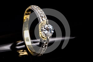 Engagement ring of yellow and white gold with sparkling diamond