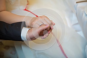 Engagement rings .The girl and the boy put their hands. Bride and groom with Engagement gold rings put their hands