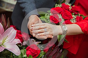 Engagement rings .The girl and the boy put their hands . Bride and groom with Engagement gold rings put their hands