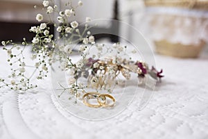 Engagement rings for a wedding with small flowers behind