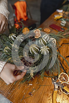 Engaging in a masterclass, a young lady creates Christmas decorations.