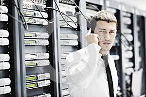 It engeneer talking by phone at network room