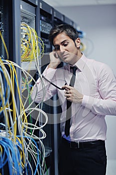 It engeneer talking by phone at network room