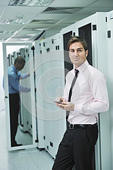 It engeneer talking by phone at network room