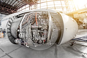 Engine of the aircraft with an open hood for repair and inspection.