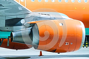 Engine of the airplane painted in orange. Close-up