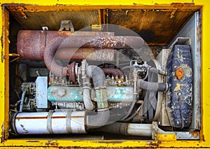 Engine bay of an old and rusty excavator