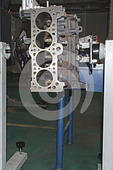 The engine block installed on the engine repair stand during the repair process. Vertical photo