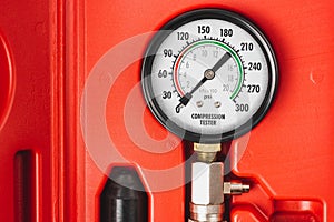 Engine compression tester. Set for testing the internal combustion engine. Monometer close-up.