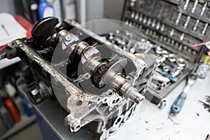 Engine crankshaft, valve cover, pistons. mechanic repairman at automobile car engine maintenance repair work