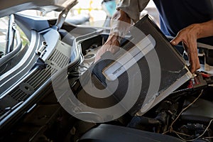 Engine engineer is replacing car battery because car battery is depleted