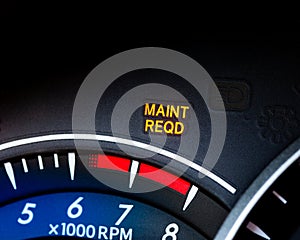 Engine maintenance or service light is on in car dashboard. Car dashboard cluster background