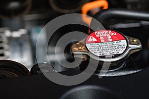 Engine radiator cap with warning labels