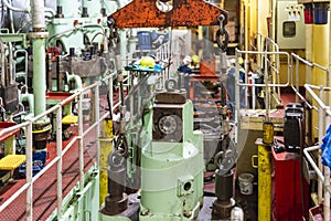Engine room of a merchant ship showcasing maintenance work on a main engine.