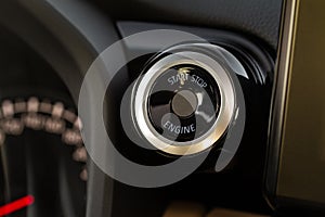 Engine start button with fingerpint close up.