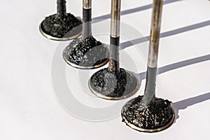 Engine valves in oil covered with soot. Heat-resistant steel. Automotive, repair servicing