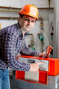 Engineer adjusting heating work on automated control dashboard