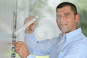 It engineer adjusts air conditioner in datacenter