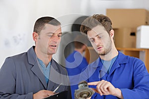 engineer and apprentice discussing component