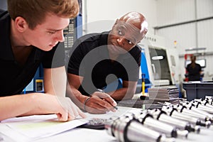 Engineer And Apprentice Planning CNC Machinery Project