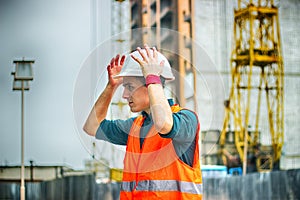 Engineer or Architect checking personal protective equipment safety helmet at construction site