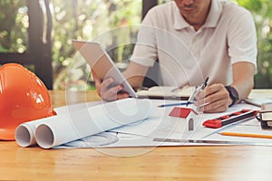 Engineer and Architect concept, Close up house model on Interior designer desk with blueprint