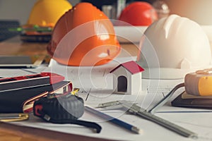 Engineer and Architect concept, House model and blueprint on office desk