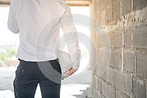 Engineer or Architect holding protective safety helmet