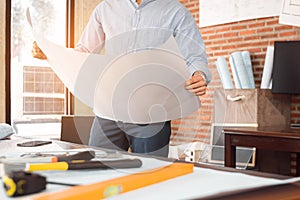 Engineer or Architect is reading paper blueprint project plan. Civil engineering, Architect concept photo