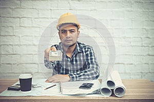 Engineer or Architect sitting, working at his desk in the office