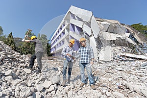 Engineer architect and worker operation control demolish old building