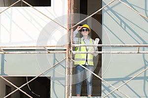 Engineer or architect working on the construction site, double-checking plans